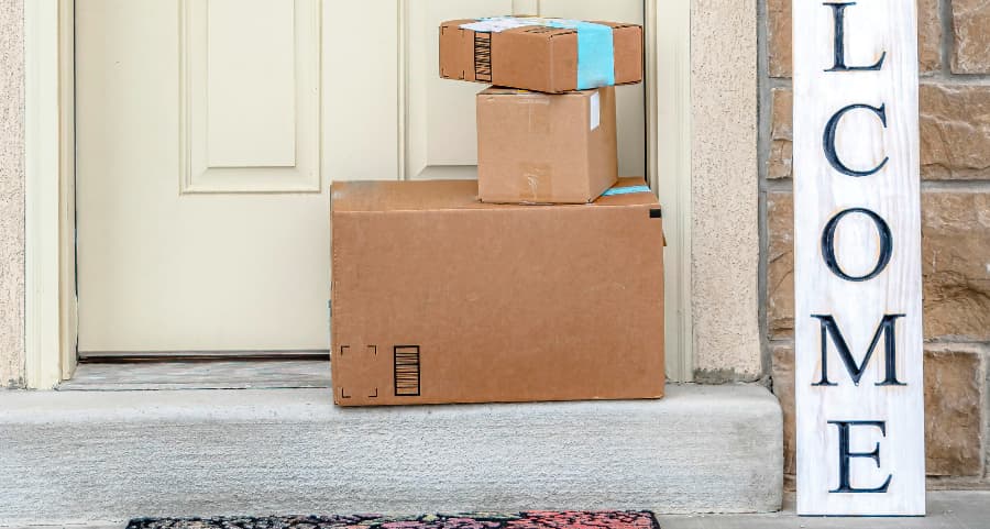 Deliveries on the front porch of a house with a welcome sign in Scottsdale